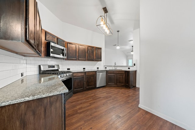 150 Primrose Blvd, Kyle, TX 78640 - kitchen with appliances with stainless steel finishes, tasteful backsplash, dark wood finished floors, and dark brown cabinets