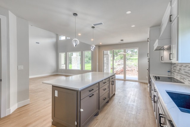 625 Desert Rose N, Horseshoe Bay, TX 78657 - kitchen with black electric stovetop, light wood-style floors, decorative backsplash, baseboards, and recessed lighting