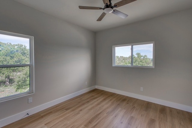 625 Desert Rose N, Horseshoe Bay, TX 78657 - unfurnished room with plenty of natural light, baseboards, light wood-style flooring, and ceiling fan