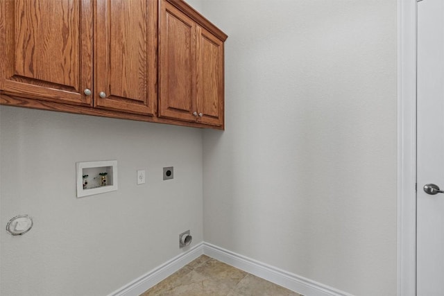 105 Longhorn Cavern Cv, Georgetown, TX 78633 - laundry area featuring cabinet space, electric dryer hookup, baseboards, hookup for a washing machine, and light tile patterned floors