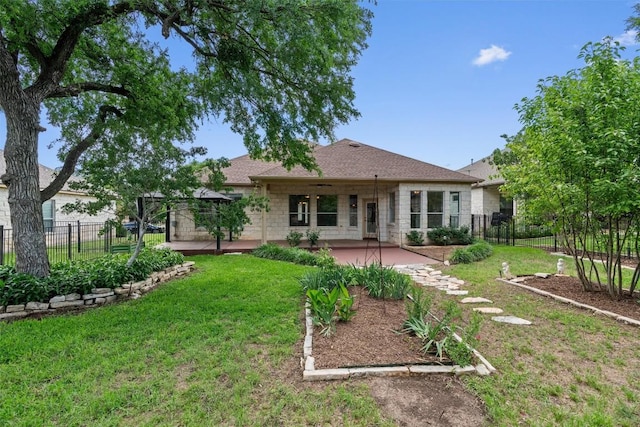 105 Longhorn Cavern Cv, Georgetown, TX 78633 - rear view of house featuring a patio area, stone siding, and roof with shingles