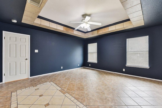 717 Blair Ave, Bastrop, TX 78602 - tiled spare room with a raised ceiling, a ceiling fan, and baseboards