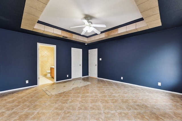 717 Blair Ave, Bastrop, TX 78602 - unfurnished room featuring a tray ceiling, ceiling fan, baseboards, and tile patterned flooring