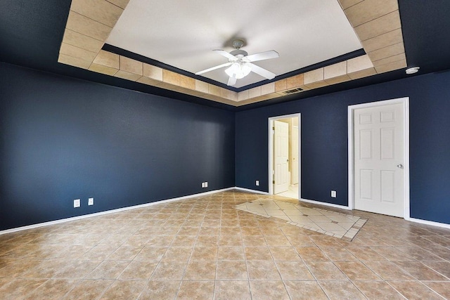 717 Blair Ave, Bastrop, TX 78602 - spare room featuring a raised ceiling, a ceiling fan, tile patterned floors, and baseboards