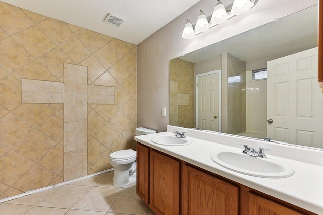 717 Blair Ave, Bastrop, TX 78602 - full bath featuring double vanity, toilet, tile patterned floors, and a shower