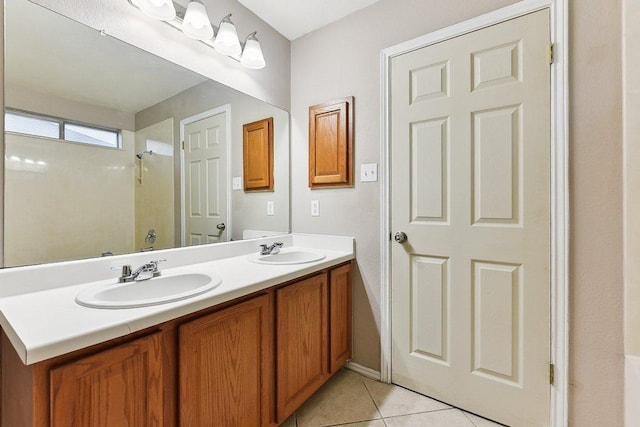 717 Blair Ave, Bastrop, TX 78602 - full bathroom featuring double vanity, a shower, and tile patterned flooring