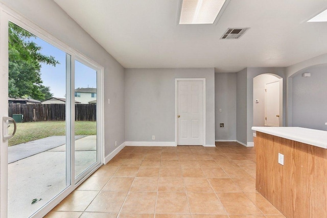 717 Blair Ave, Bastrop, TX 78602 - unfurnished room with baseboards, light tile patterned floors, and arched walkways