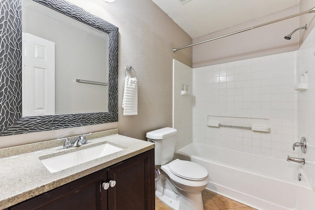 717 Blair Ave, Bastrop, TX 78602 - full bathroom with shower / washtub combination, toilet, vanity, tile patterned flooring, and a textured wall
