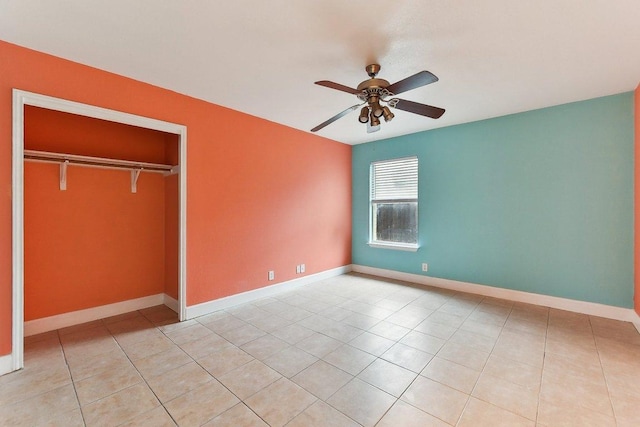 717 Blair Ave, Bastrop, TX 78602 - unfurnished bedroom featuring light tile patterned flooring, baseboards, a closet, and a ceiling fan