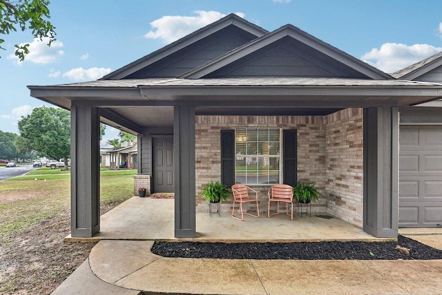 717 Blair Ave, Bastrop, TX 78602 - property entrance with a porch and brick siding