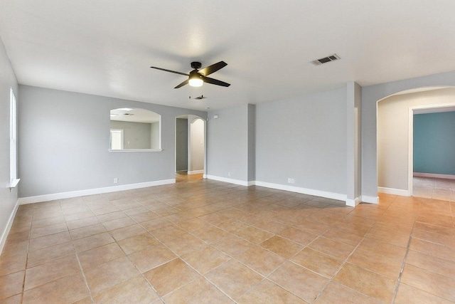 717 Blair Ave, Bastrop, TX 78602 - spare room with light tile patterned floors, arched walkways, and a ceiling fan