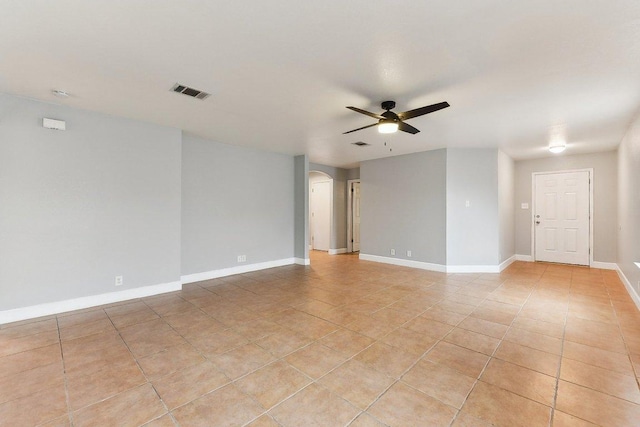 717 Blair Ave, Bastrop, TX 78602 - empty room featuring a ceiling fan, arched walkways, light tile patterned flooring, and baseboards