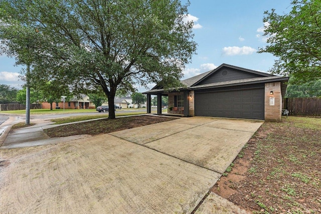 717 Blair Ave, Bastrop, TX 78602 - view of side of property with concrete driveway and an attached garage