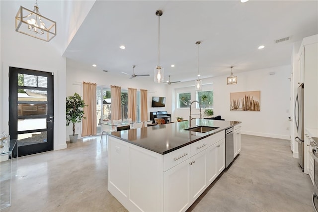 5506 Evans Ave Unit 1, Austin, TX 78751 - kitchen with finished concrete floors, a kitchen island with sink, recessed lighting, white cabinetry, and decorative light fixtures