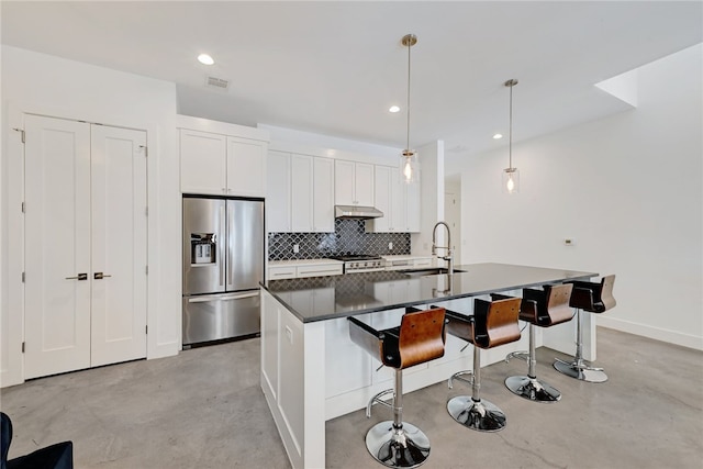 5506 Evans Ave Unit 1, Austin, TX 78751 - kitchen featuring concrete flooring, appliances with stainless steel finishes, tasteful backsplash, dark countertops, and recessed lighting