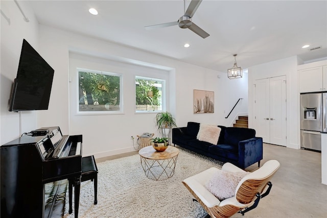 5506 Evans Ave Unit 1, Austin, TX 78751 - living room featuring concrete floors, ceiling fan, recessed lighting, stairway, and a chandelier