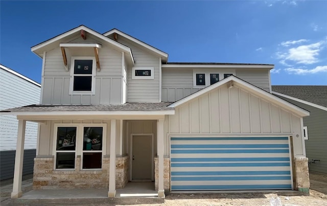 5315 Bruno St, Round Rock, TX 78665 - view of front facade with board and batten siding, an attached garage, roof with shingles, and stone siding