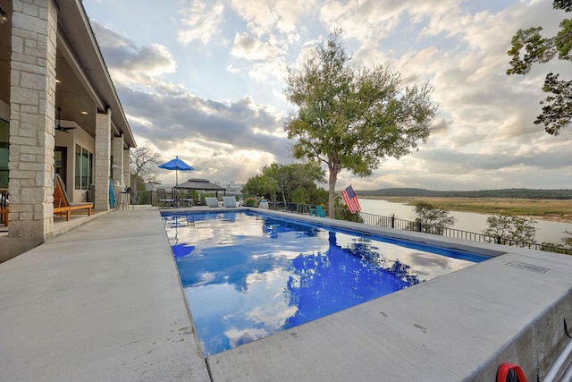 view of swimming pool with fence and a patio area
