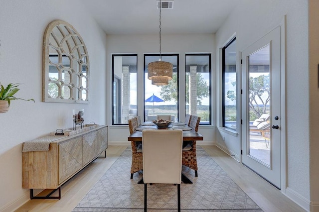 dining room with light wood-style flooring and baseboards