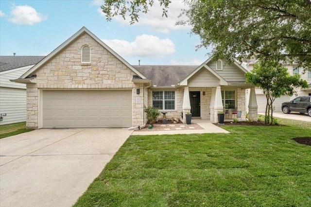 view of front of property featuring a garage, stone siding, driveway, a front yard, and a shingled roof