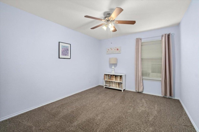 carpeted empty room featuring ceiling fan and baseboards