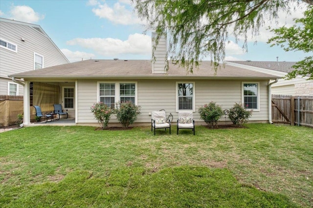 back of property with a patio area and a chimney