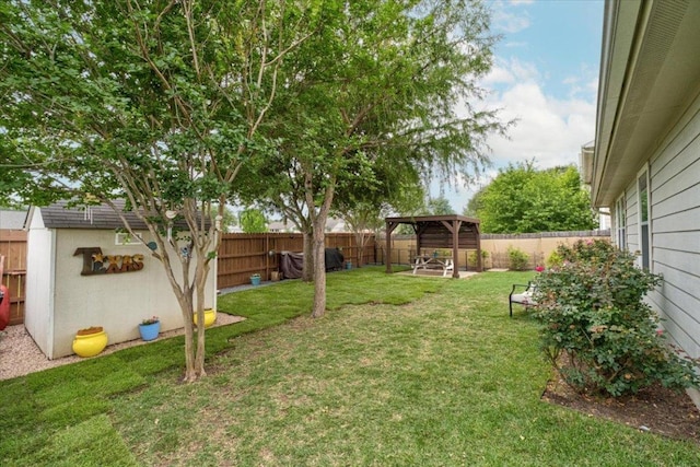 view of yard with an outbuilding, a gazebo, and a storage unit