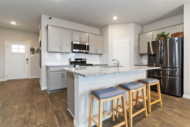118 Ballyneal Ln, San Marcos, TX 78666 - kitchen with stainless steel appliances, gray cabinetry, dark wood-style flooring, and recessed lighting