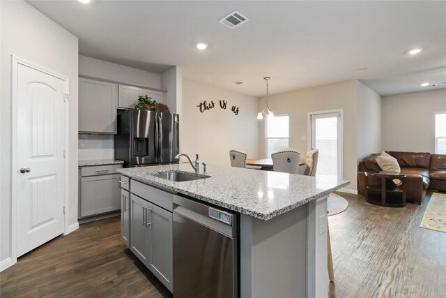 118 Ballyneal Ln, San Marcos, TX 78666 - kitchen with gray cabinets, stainless steel appliances, dark wood-type flooring, light stone countertops, and recessed lighting