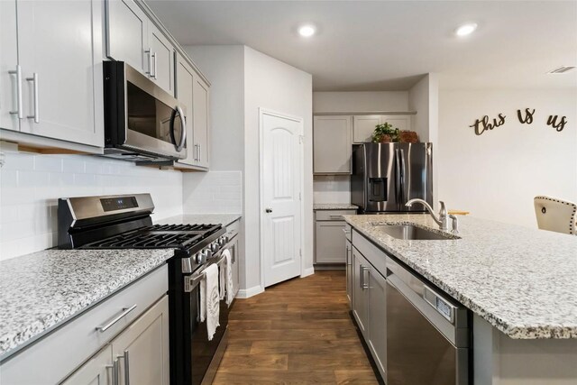 118 Ballyneal Ln, San Marcos, TX 78666 - kitchen with stainless steel appliances, gray cabinets, dark wood-style floors, tasteful backsplash, and recessed lighting