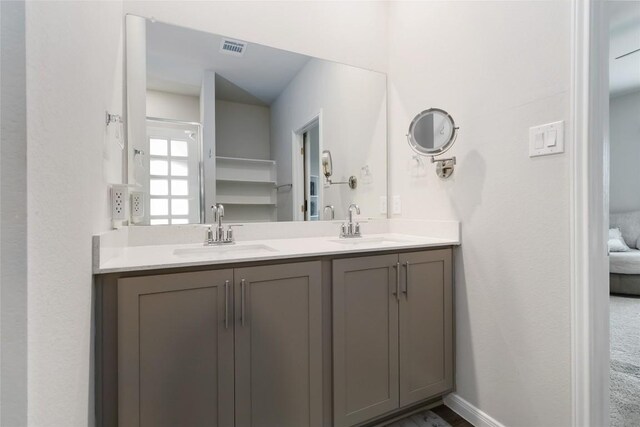 118 Ballyneal Ln, San Marcos, TX 78666 - full bathroom with double vanity and baseboards