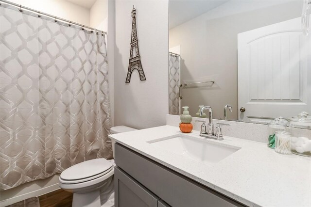 118 Ballyneal Ln, San Marcos, TX 78666 - bathroom with vanity, wood finished floors, and shower / bath combo with shower curtain