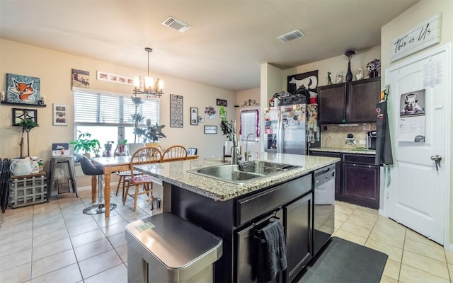 1714 Deodara Dr, Cedar Park, TX 78613 - kitchen with stainless steel refrigerator with ice dispenser, a chandelier, dishwasher, light tile patterned floors, and hanging light fixtures