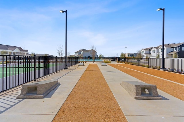 view of home's community featuring a residential view and fence