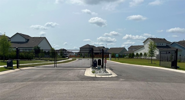 5311 Bruno St, Round Rock, TX 78665 - view of asphalt road featuring a residential view, a gate, and curbs