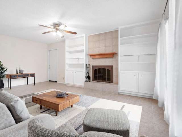 3513 Westchester Ave, Austin, TX 78759 - living room with built in features, a ceiling fan, light tile patterned floors, and a tiled fireplace
