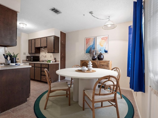 3513 Westchester Ave, Austin, TX 78759 - dining room featuring a textured ceiling and light tile patterned flooring