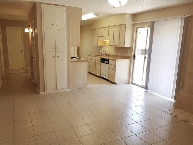 3513 Westchester Ave, Austin, TX 78759 - kitchen with a textured ceiling, plenty of natural light, white dishwasher, light tile patterned flooring, and light countertops