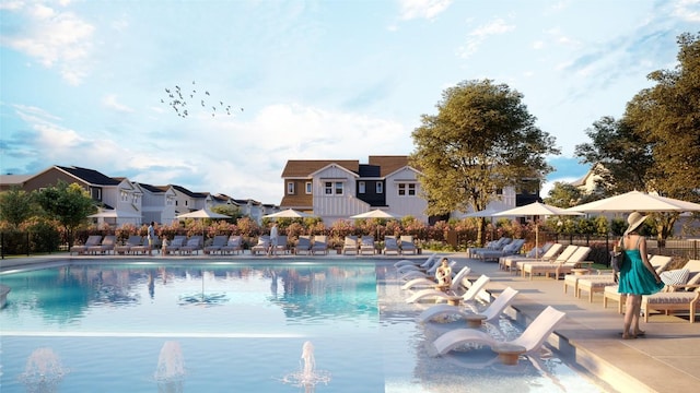 community pool featuring a residential view, a patio, and fence