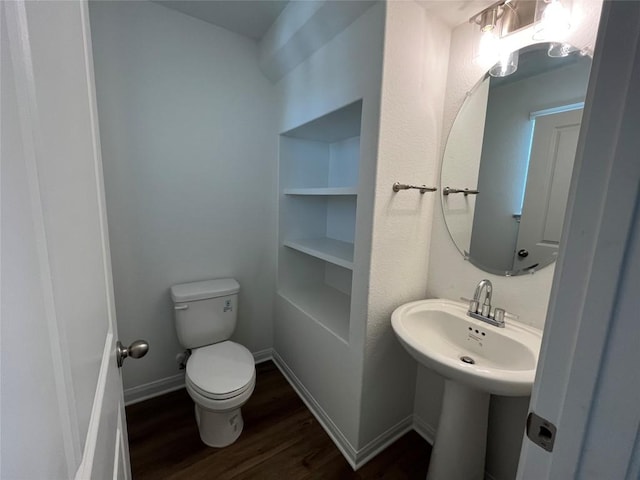 8525 Wellspring Loop, Round Rock, TX 78665 - half bathroom with wood finished floors and toilet