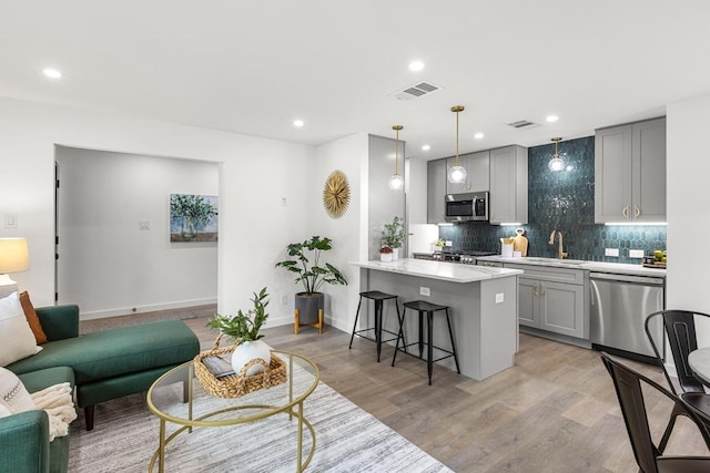 living area featuring light wood-style flooring, recessed lighting, and baseboards