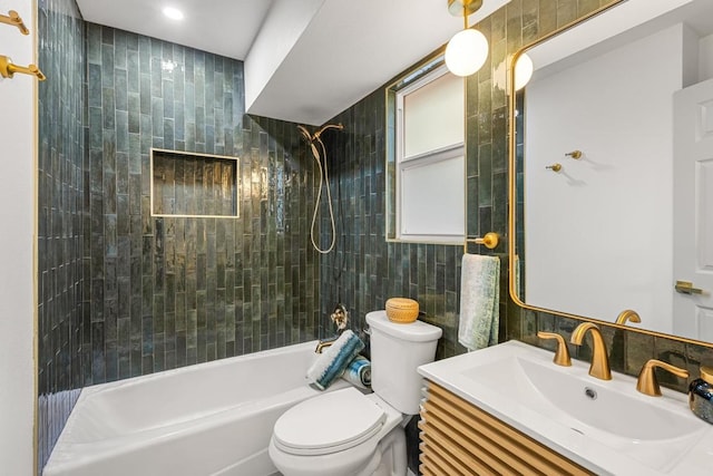 bathroom featuring tile walls, tub / shower combination, toilet, and vanity