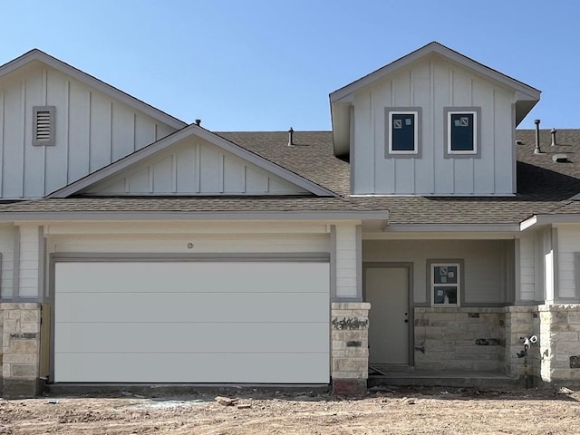 8521 Wellspring Loop, Round Rock, TX 78665 - view of front facade with roof with shingles, board and batten siding, and stone siding