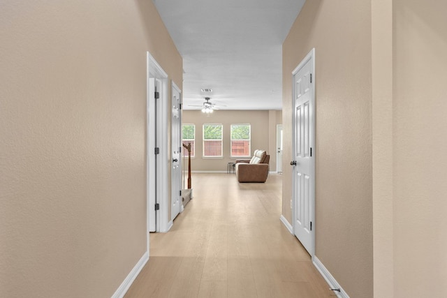 18808 Wind Valley Way, Pflugerville, TX 78660 - corridor with baseboards and light wood finished floors