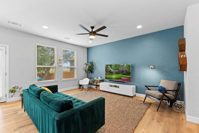 living room featuring a ceiling fan, recessed lighting, wood finished floors, and baseboards