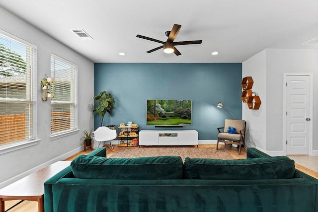 living area featuring a ceiling fan, wood finished floors, baseboards, and recessed lighting
