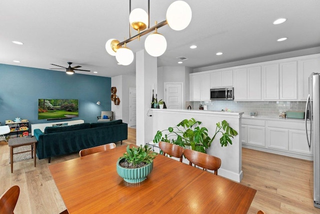 dining area with ceiling fan, light wood-style flooring, and recessed lighting