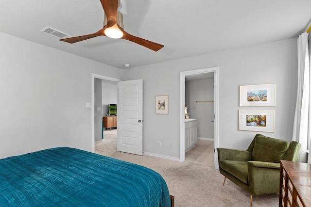 bedroom with light colored carpet, baseboards, ceiling fan, and connected bathroom
