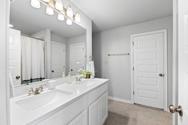 full bath featuring double vanity, baseboards, tile patterned floors, and a shower with curtain