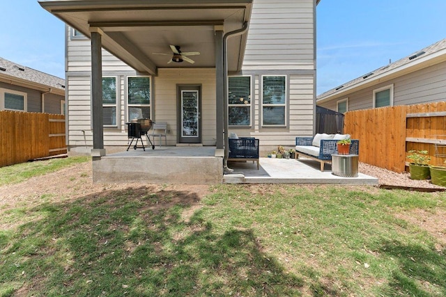 back of property with ceiling fan and a patio area